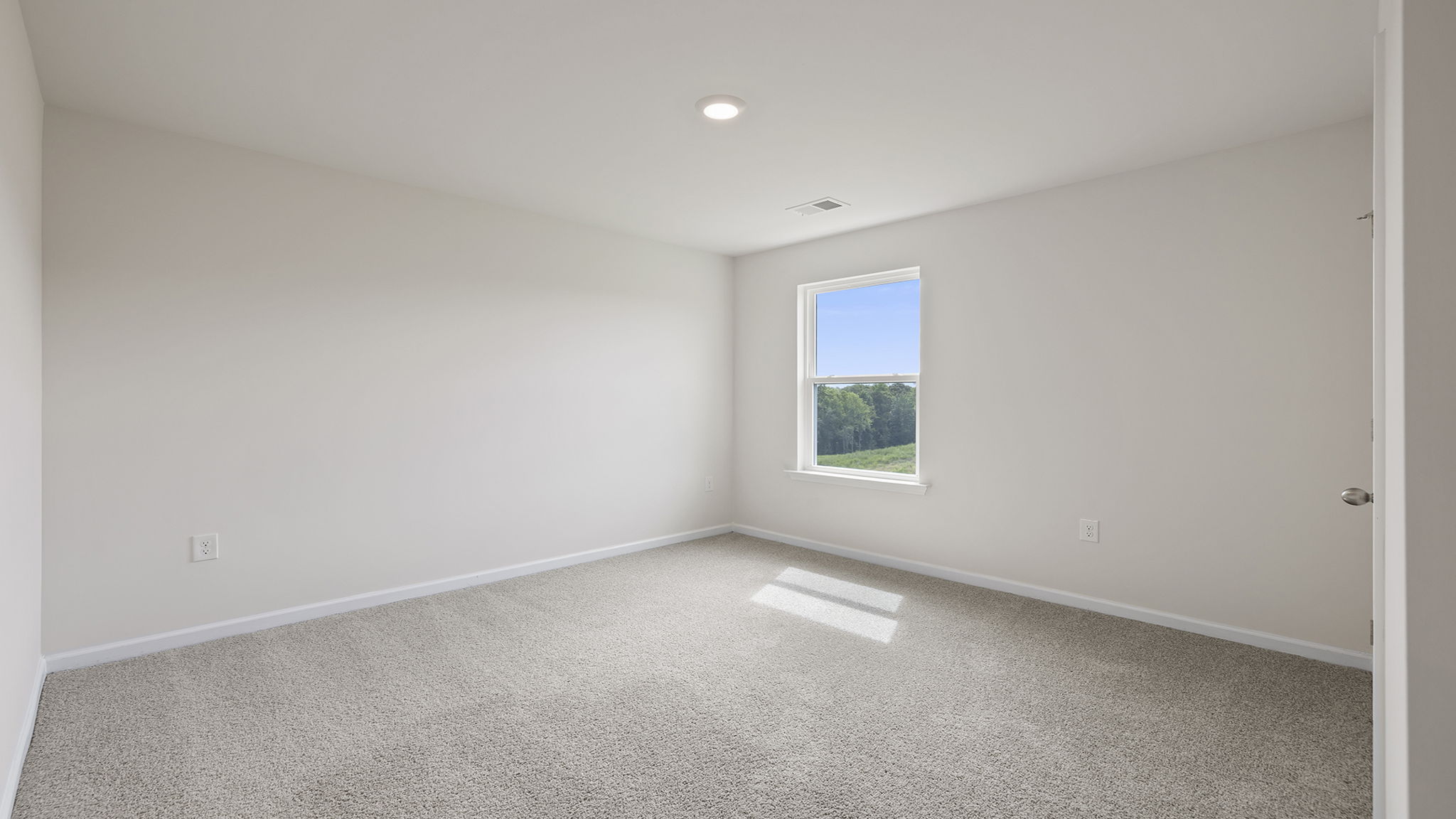 Bedroom with window and carpet.