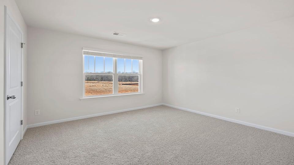 Bedroom with window and carpet.
