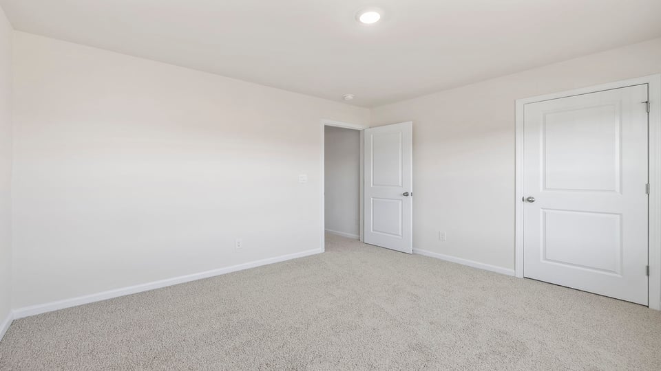 Bedroom with window and carpet.