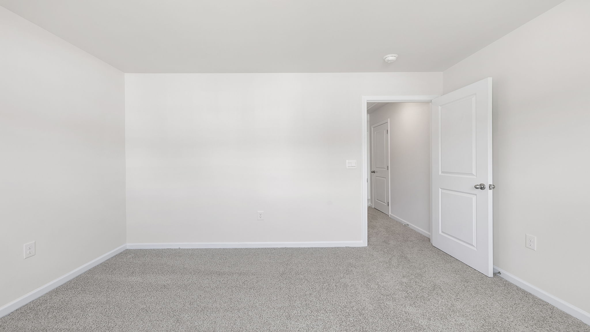 Bedroom with window and carpet.