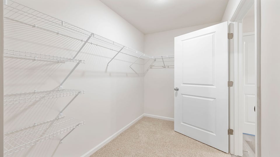 Primary bedroom walk-in closet.