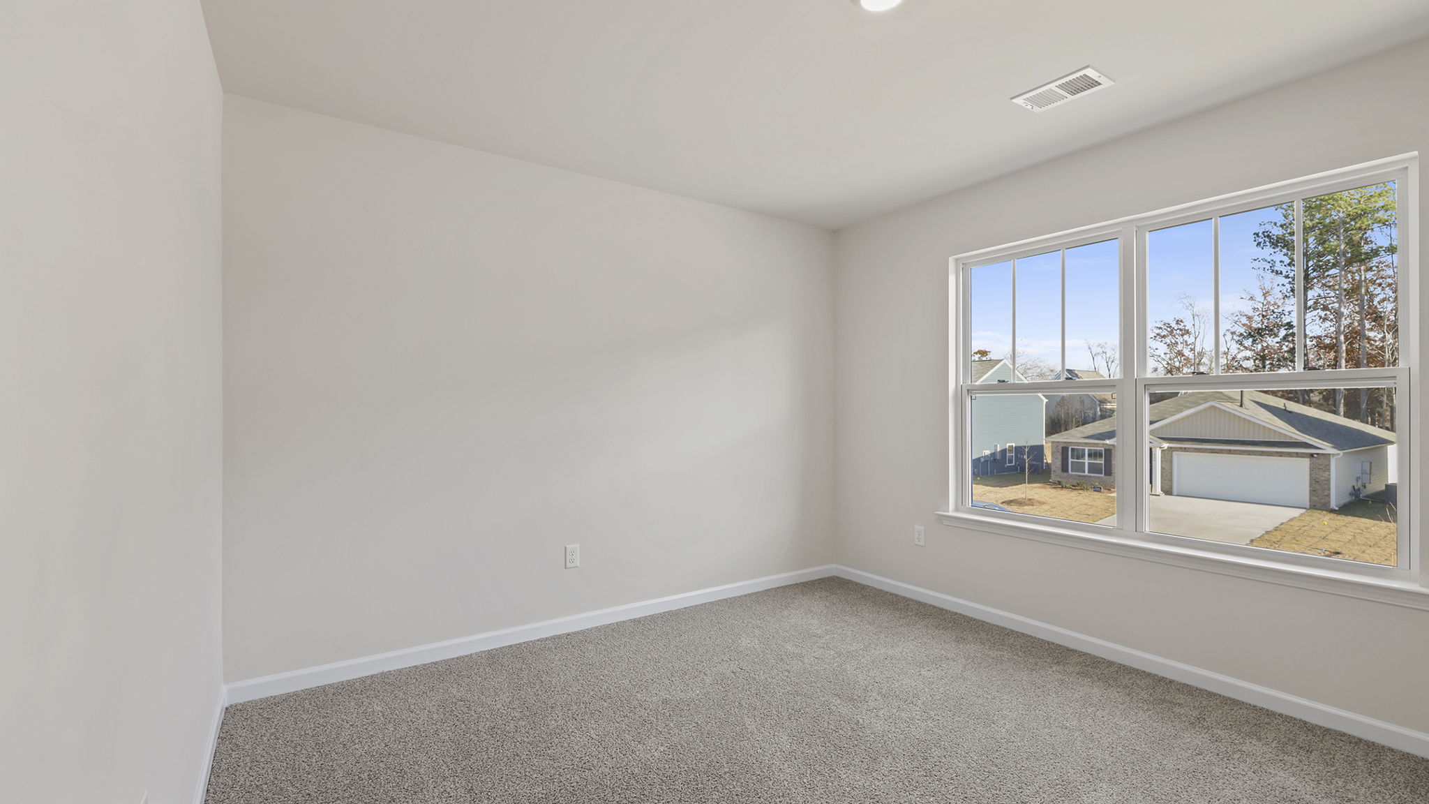 Primary bedroom with large windows.
