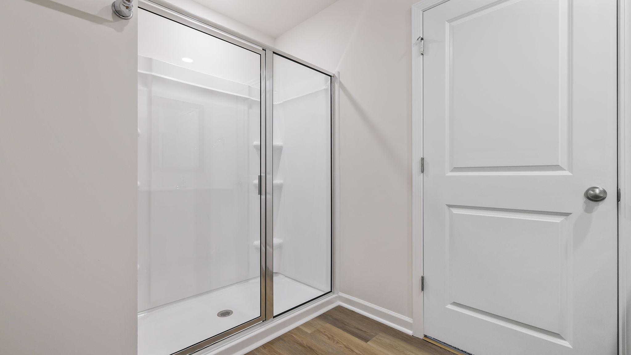 Primary bedroom with walk-in shower.