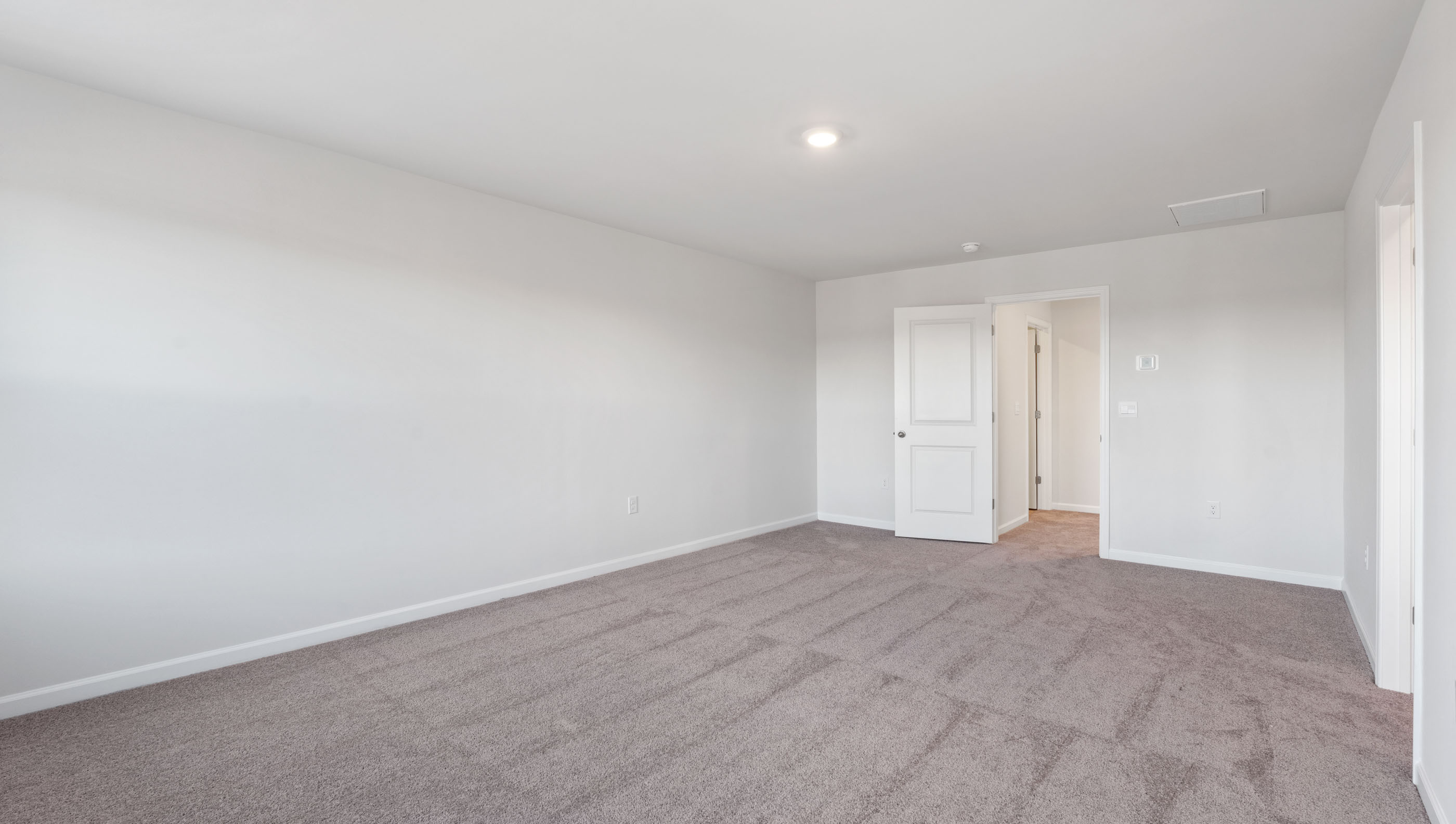 Bedroom with carpet and window.