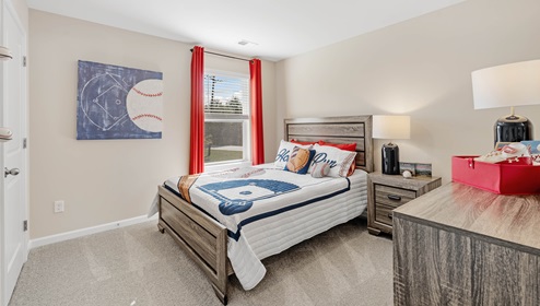 Bedroom with carpet and window.