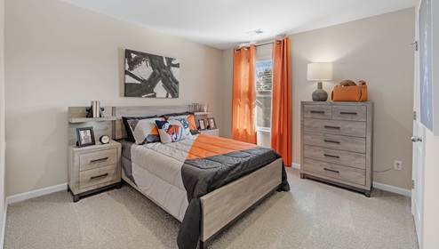 Bedroom with carpet and window.
