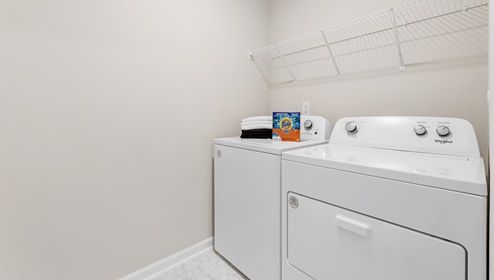 Laundry room with shelf.