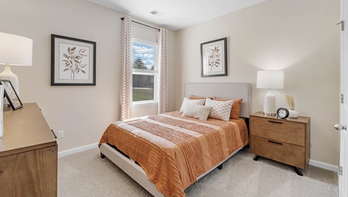 Bedroom with carpet and window.