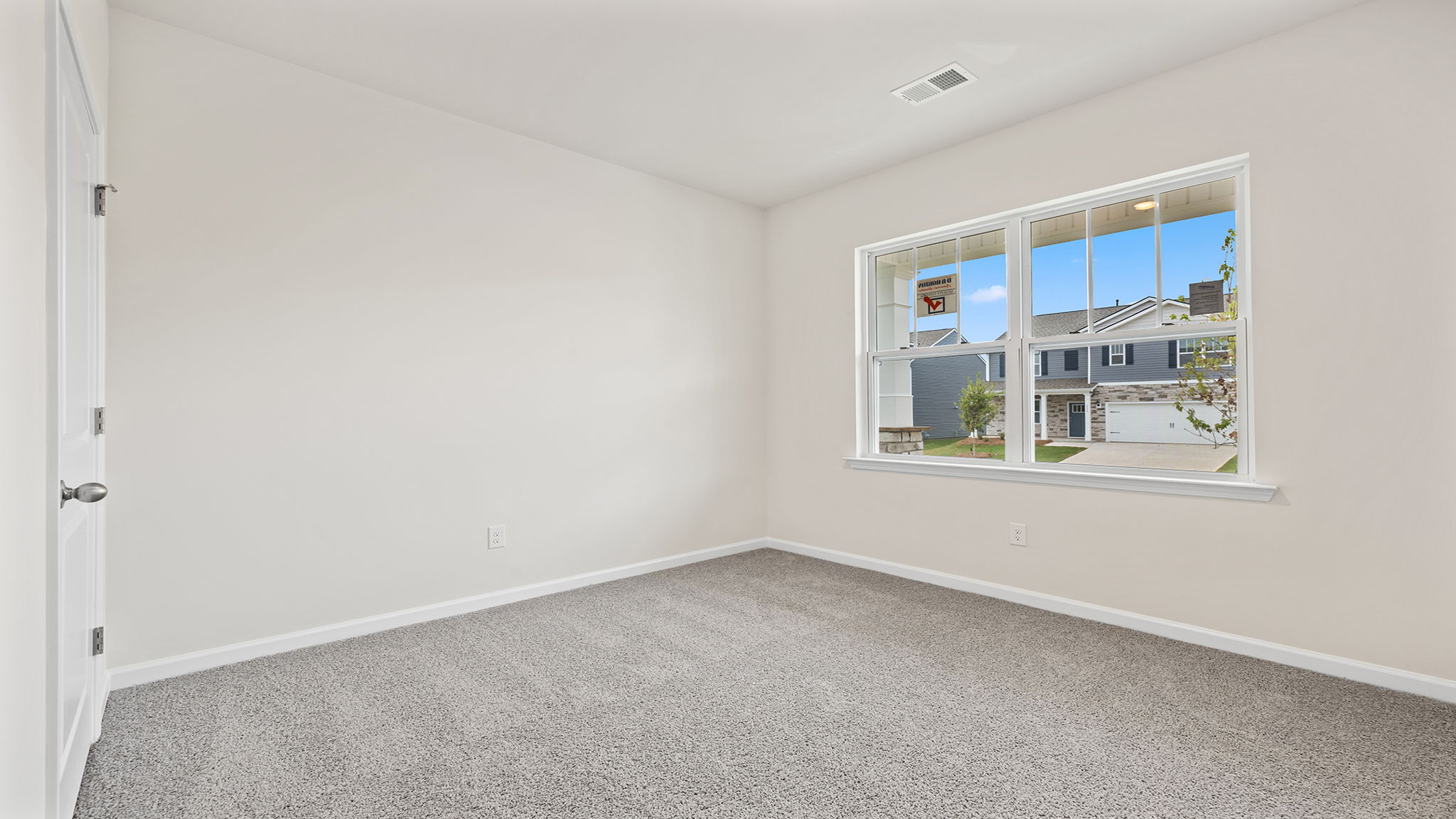 Bedroom with window and carpet.