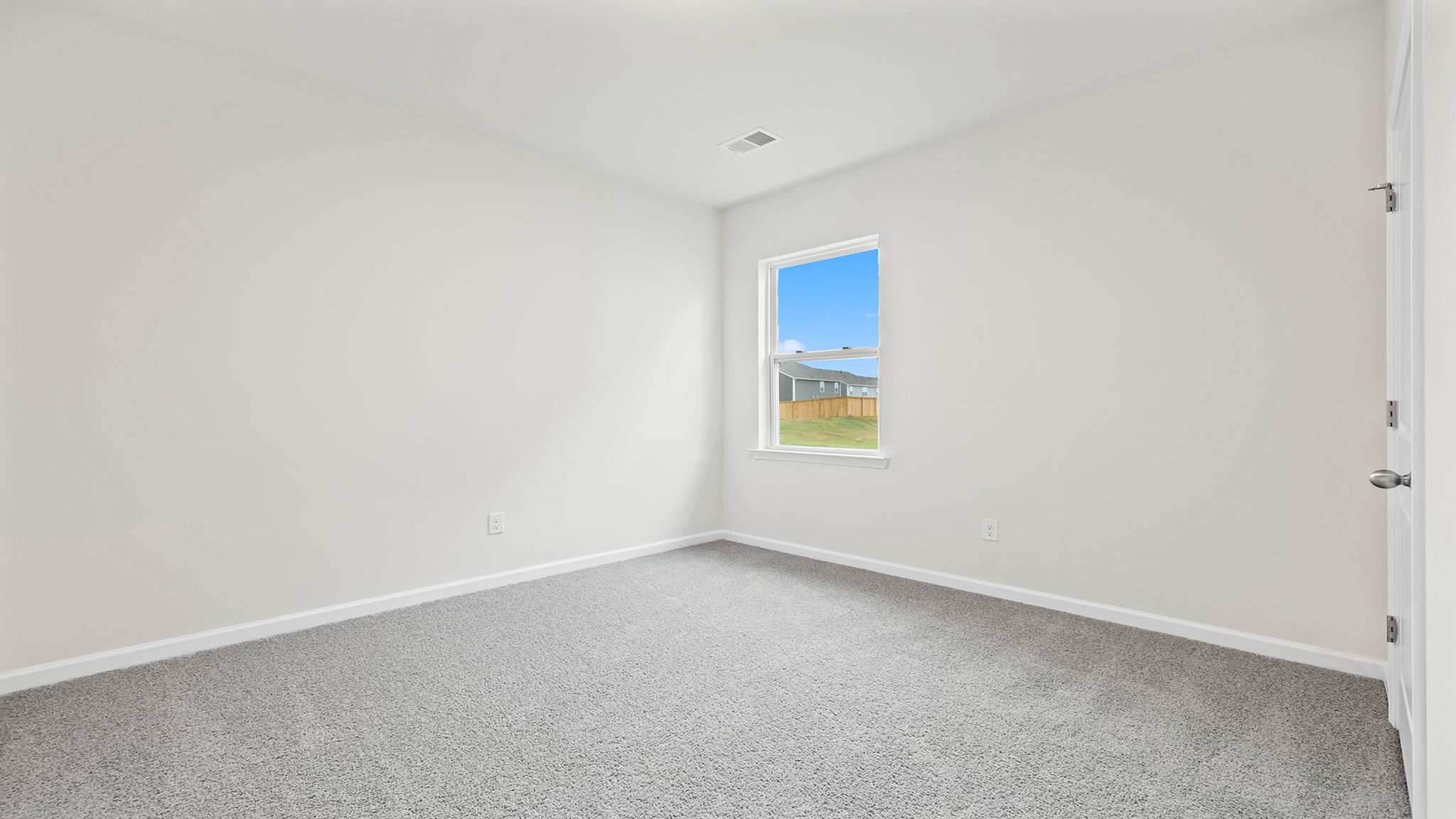 Bedroom with window and carpet.