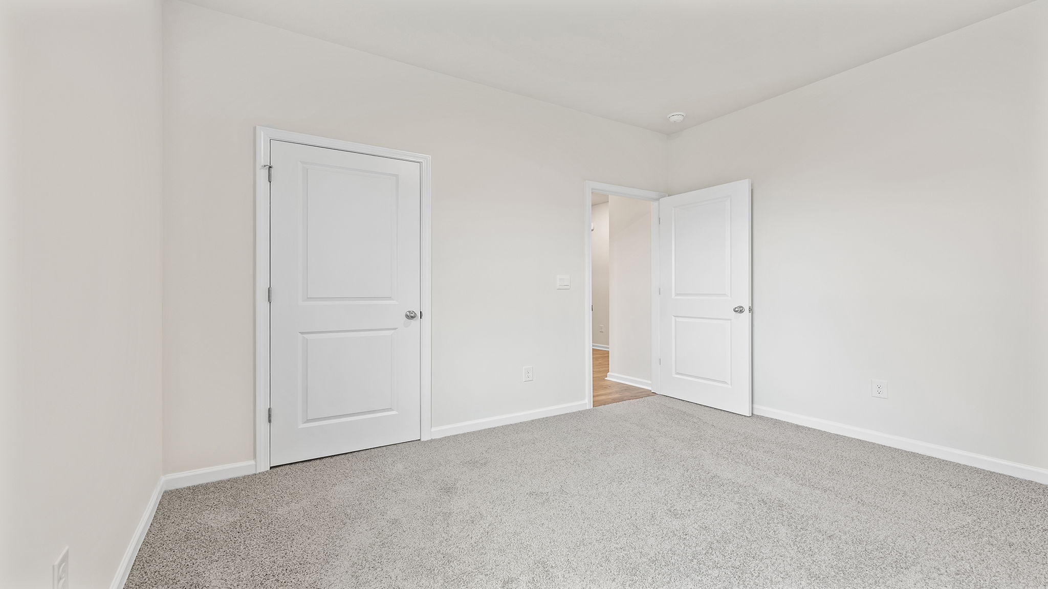 Bedroom with window and carpet.