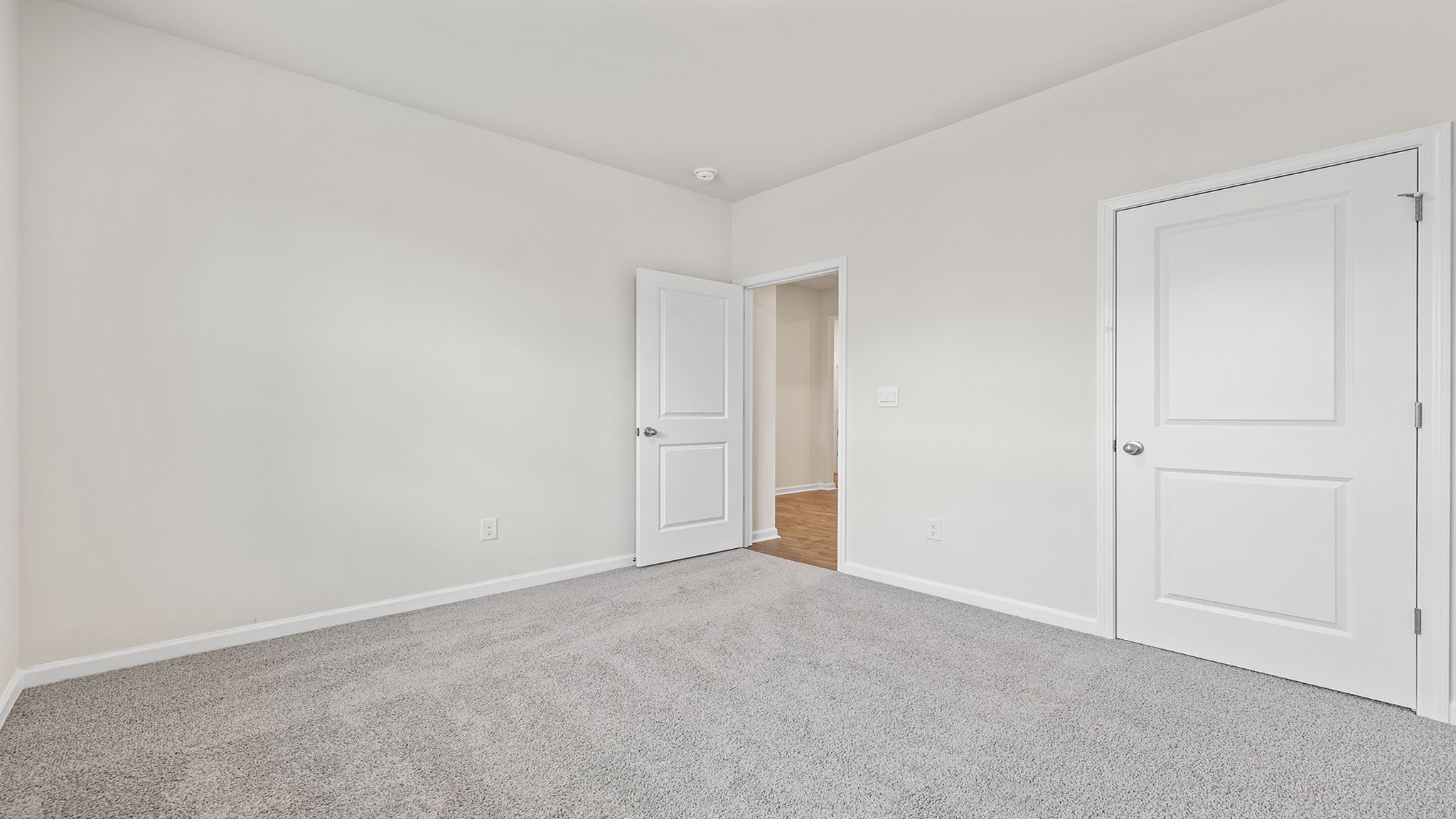 Bedroom with window and carpet.