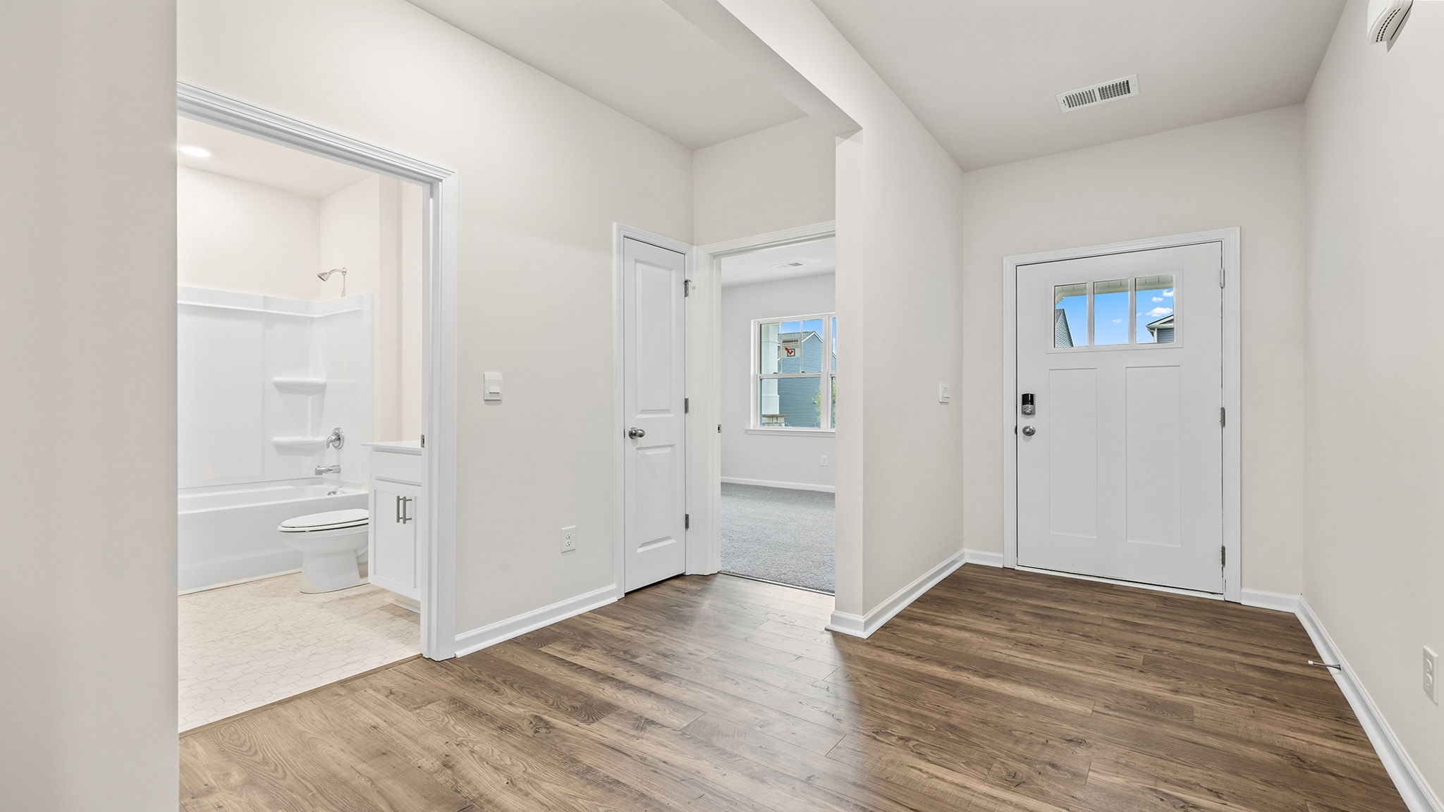 Entrance and view of front bedroom and hall bathroom.