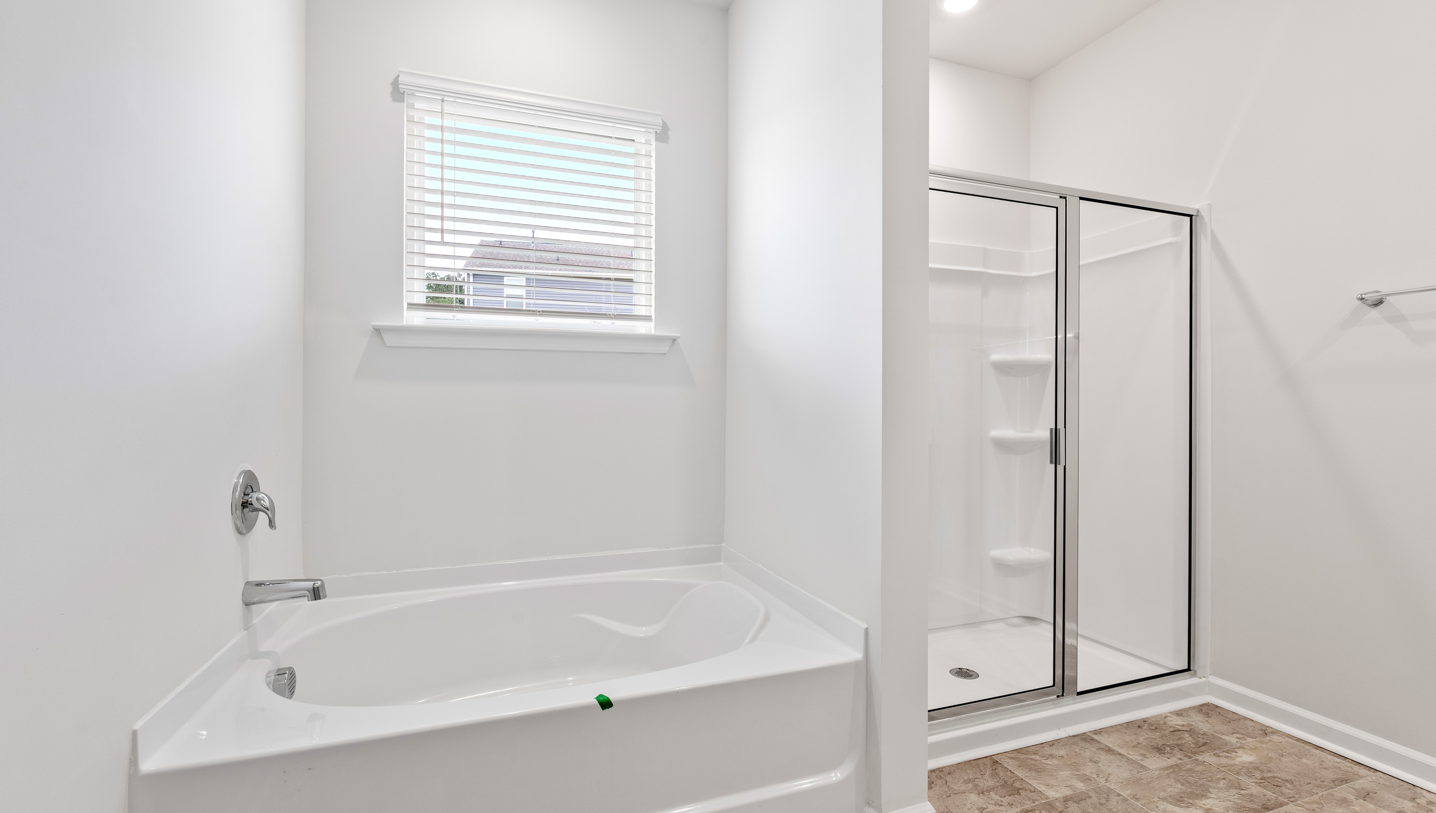 Primary bathroom with garden tub and walk-in shower.