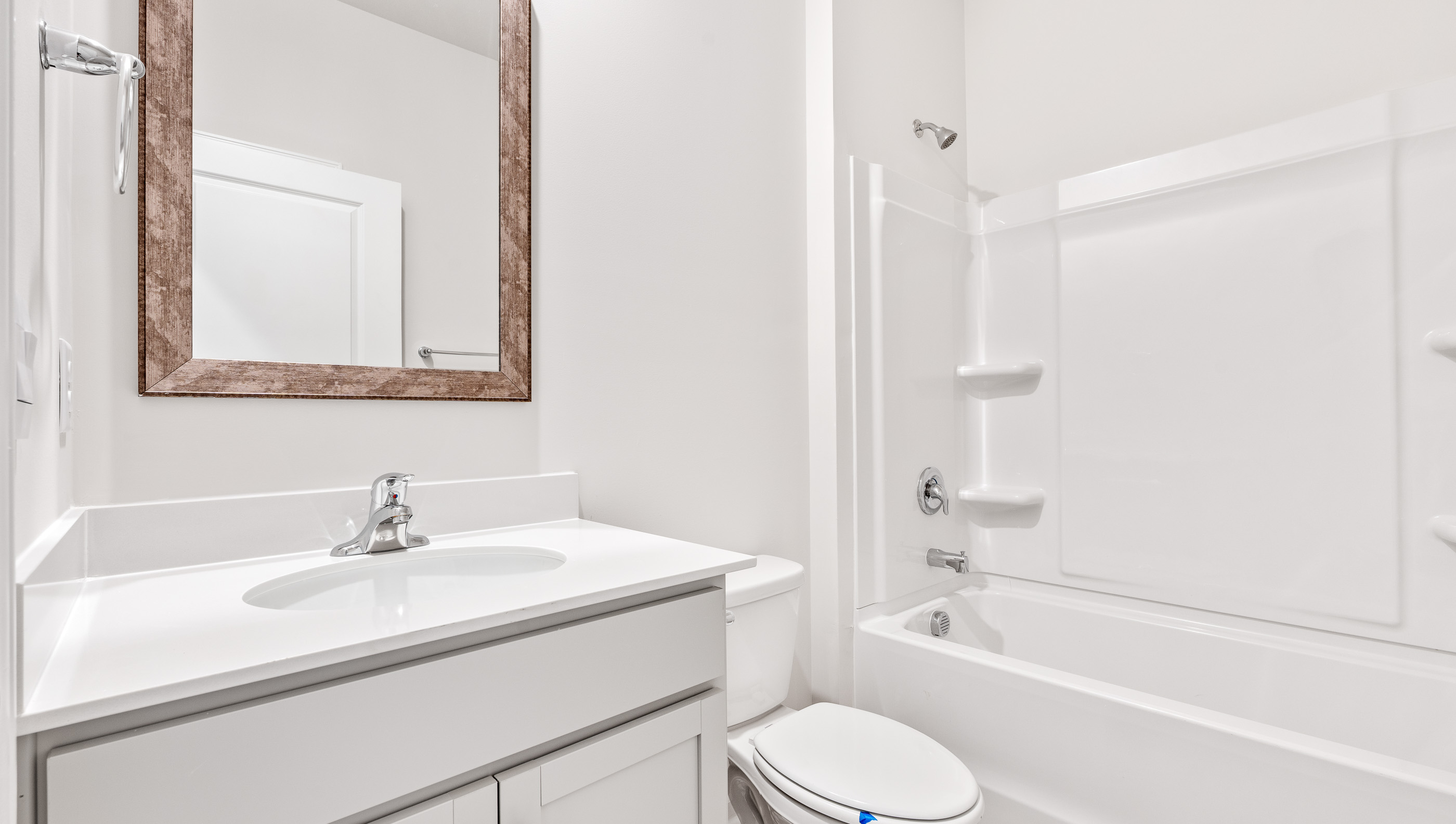 Hall bathroom with vanity and combination shower / tub.