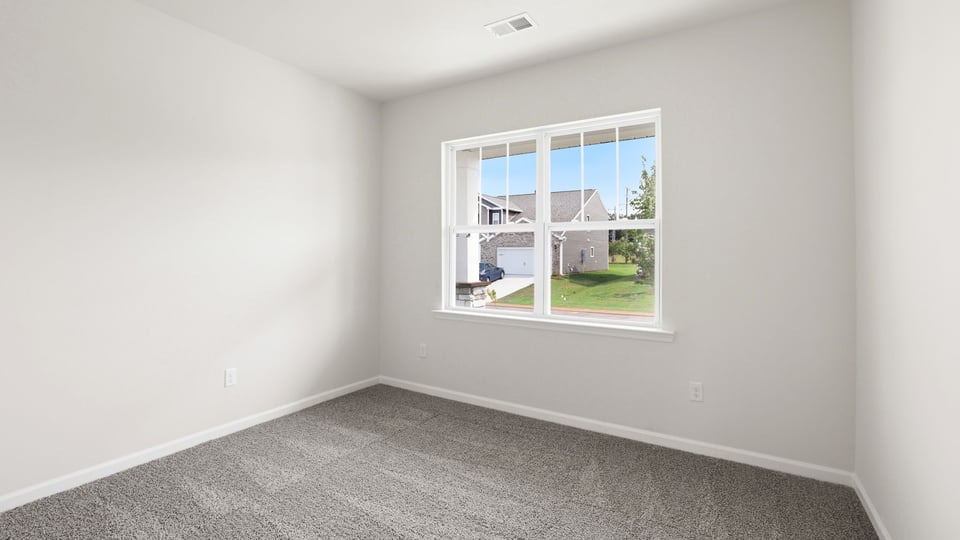 Bedroom with carpet and window.