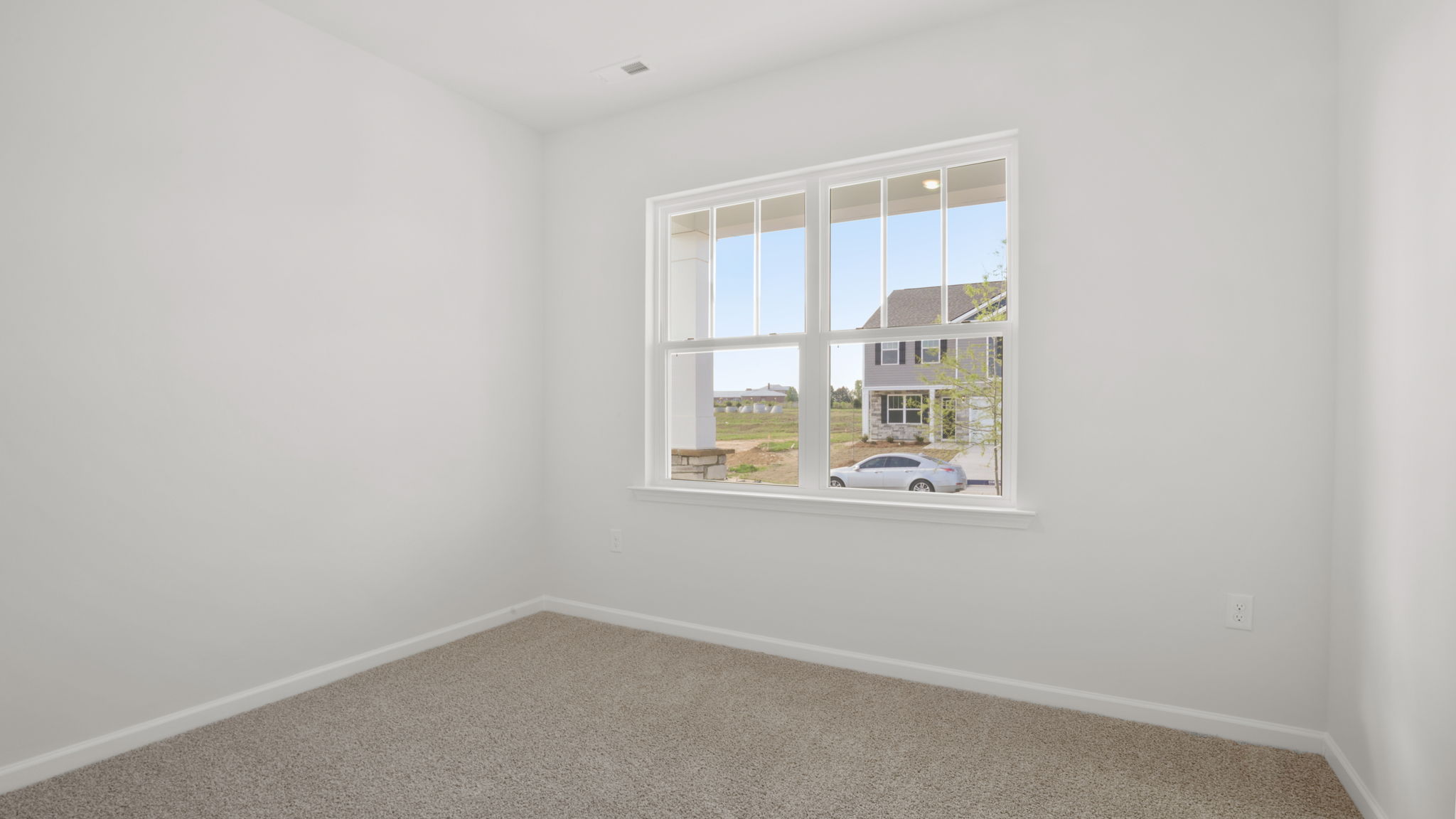 Bedroom with window and carpet.