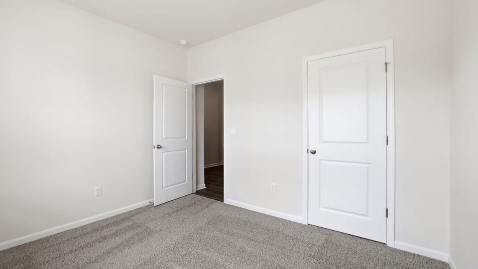 Bedroom with carpet and window.