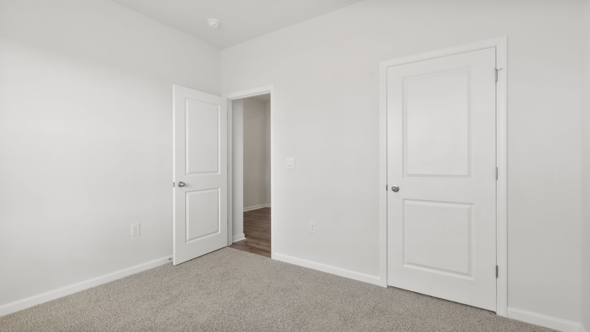Bedroom with window and carpet.
