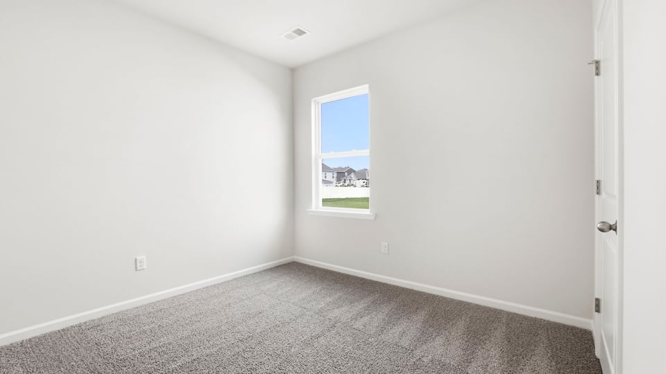 Bedroom with carpet and window.