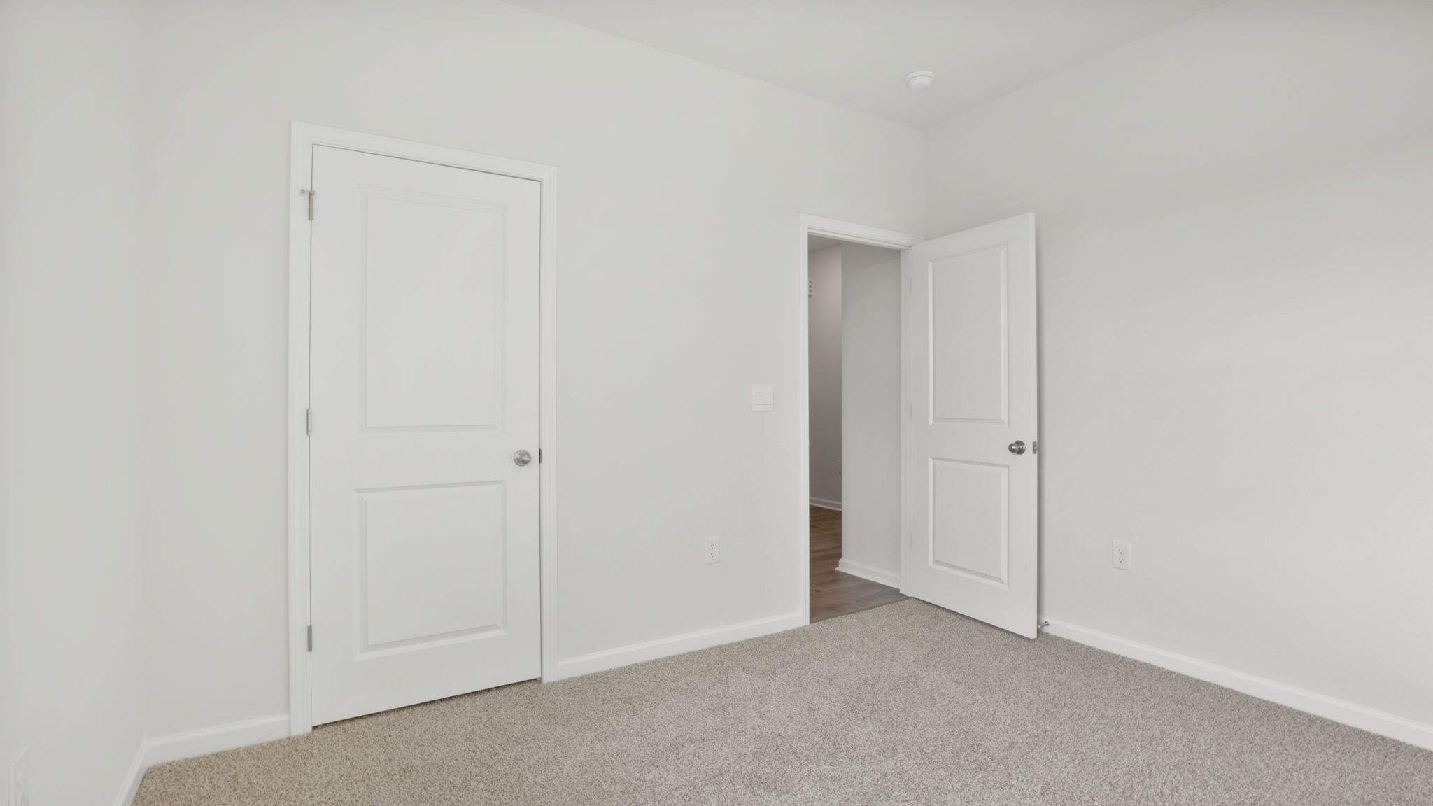 Bedroom with window and carpet.