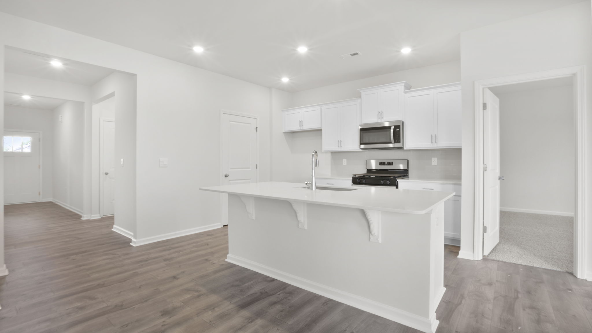 View of kitchen and hallway to the entrance.