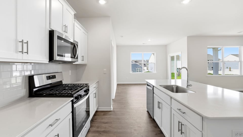Kitchen and island with quartz countertops.