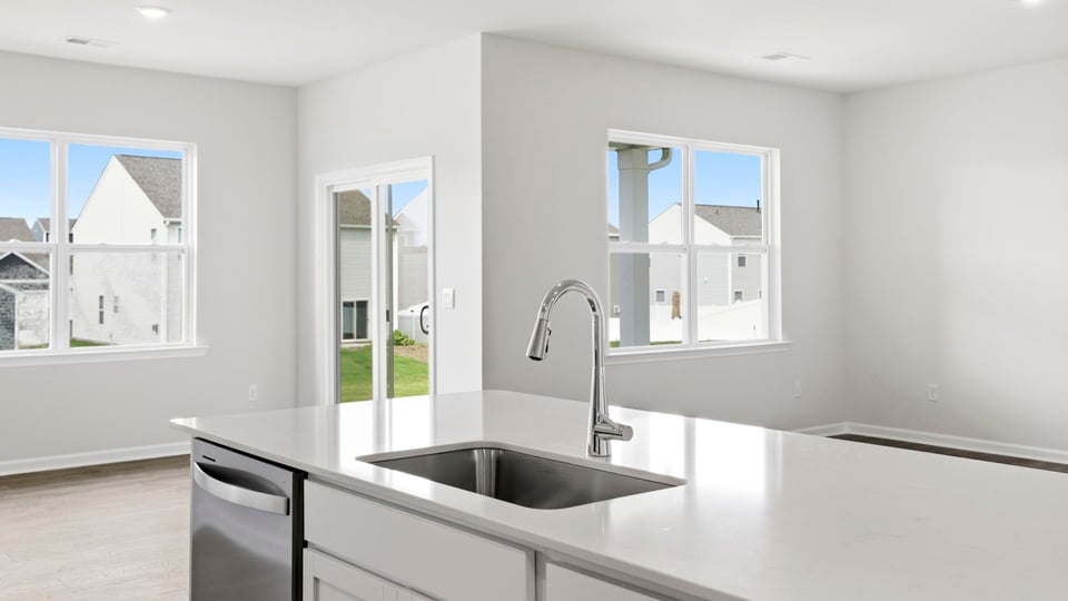 Kitchen and island with quartz countertops.
