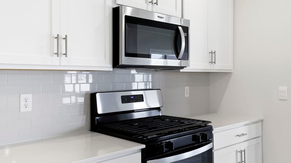 Kitchen and island with quartz countertops.