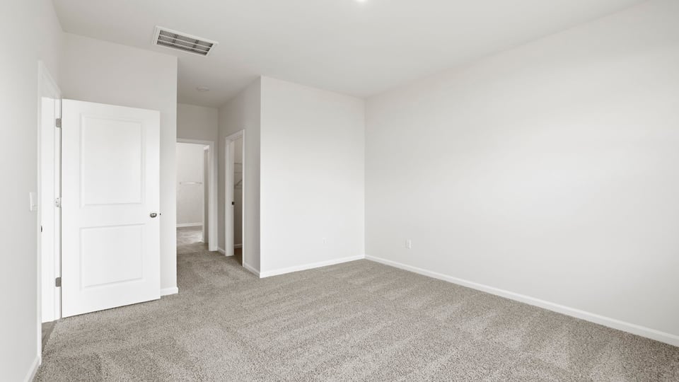 Bedroom with carpet and window.