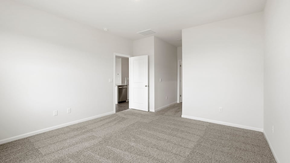 Bedroom with carpet and window.