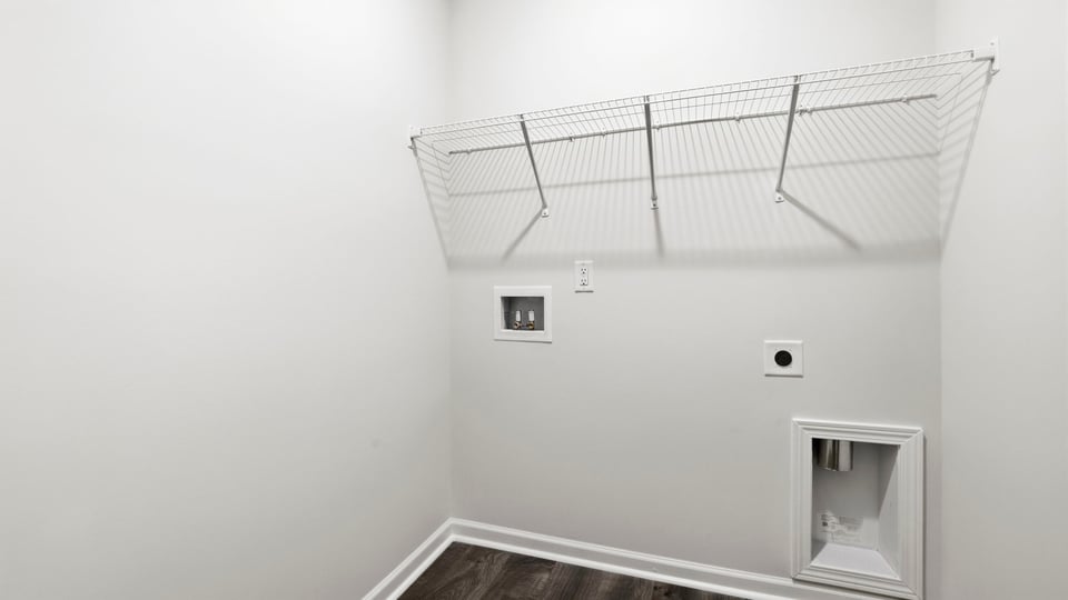 Laundry room with hanging racks.