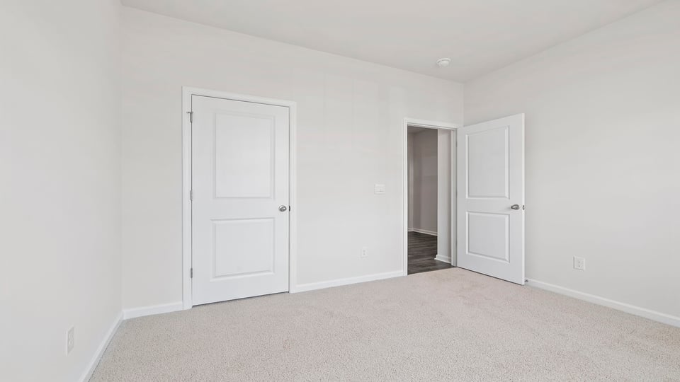Bedroom with carpet and window.