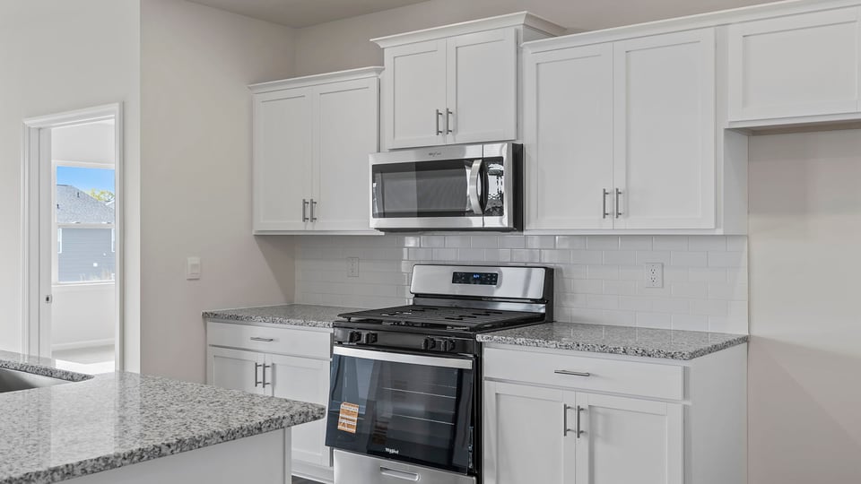 Kitchen with island and cabinets.