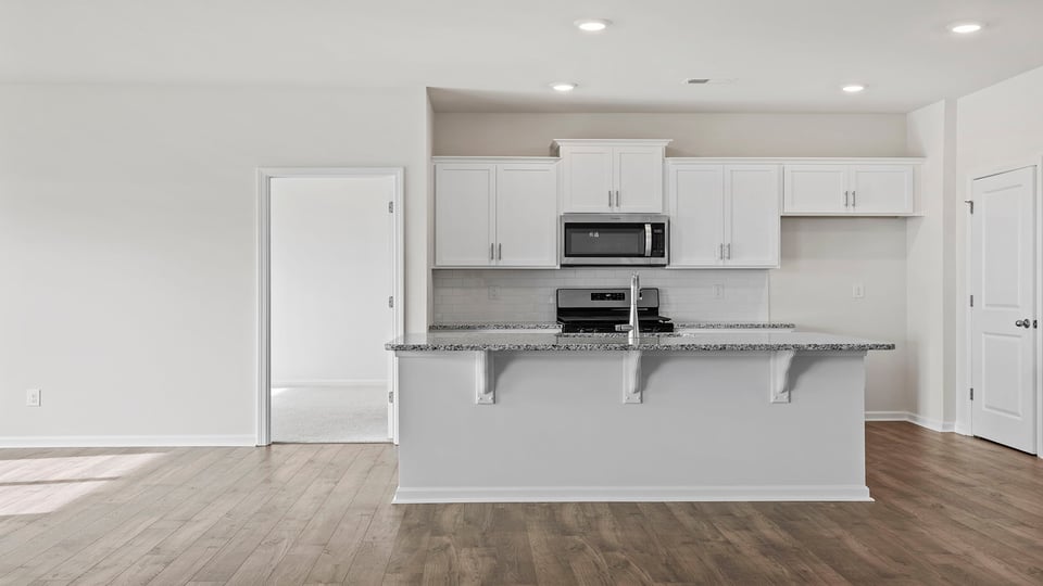 Kitchen with island and cabinets.