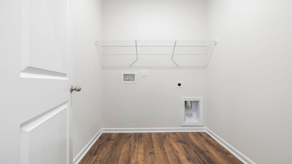 Laundry room with shelf.