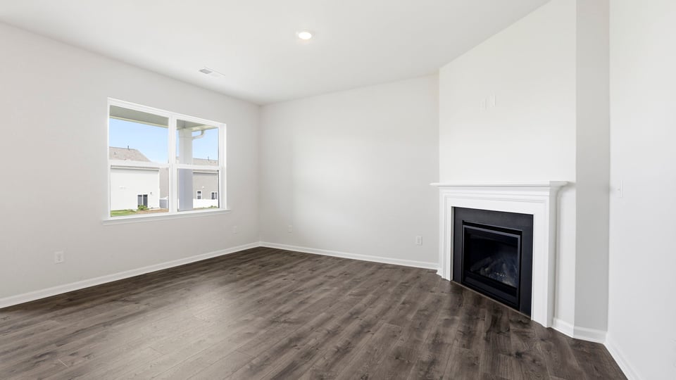 Living area with fireplace and windows.