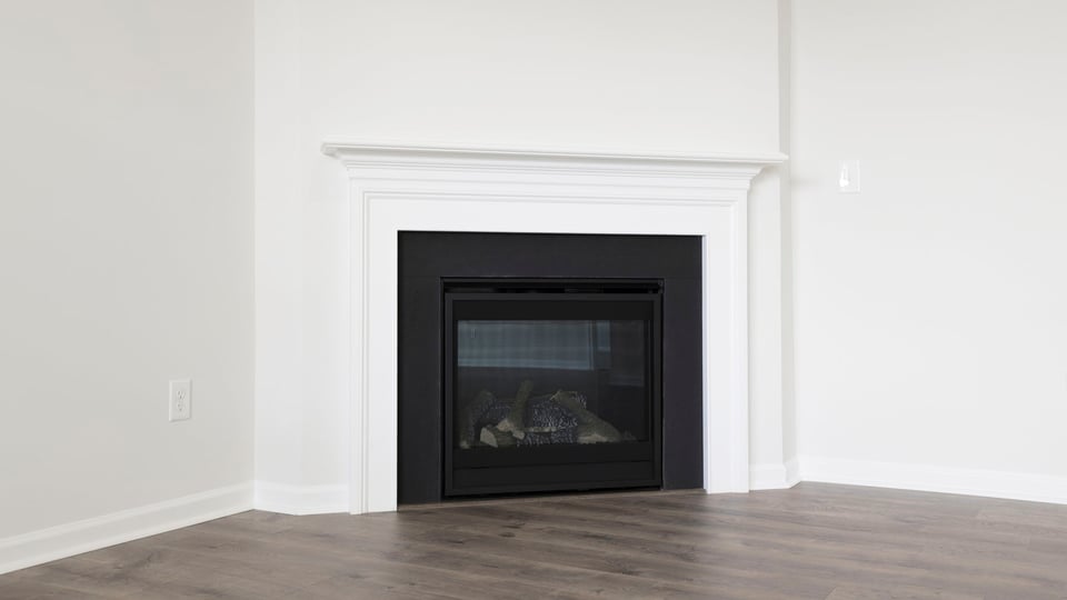 Living area with fireplace and windows.