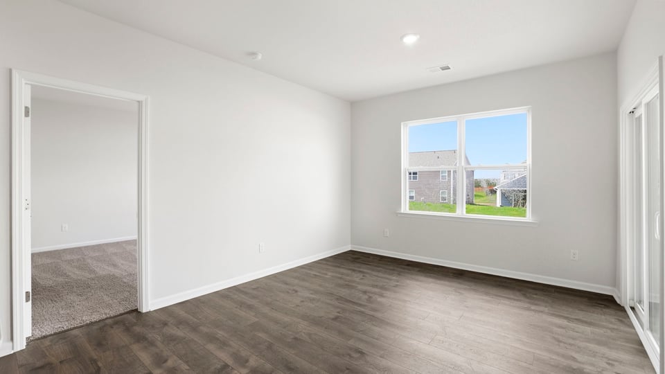 Living area with fireplace and windows.