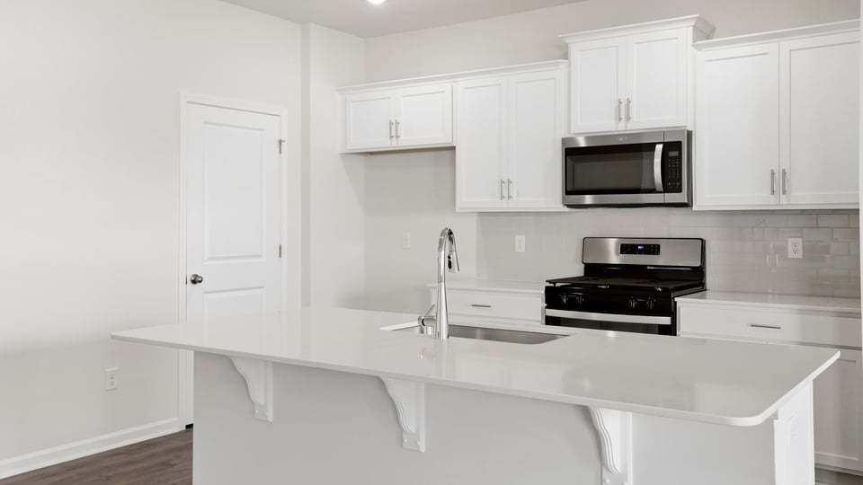 Kitchen with island and cabinets.
