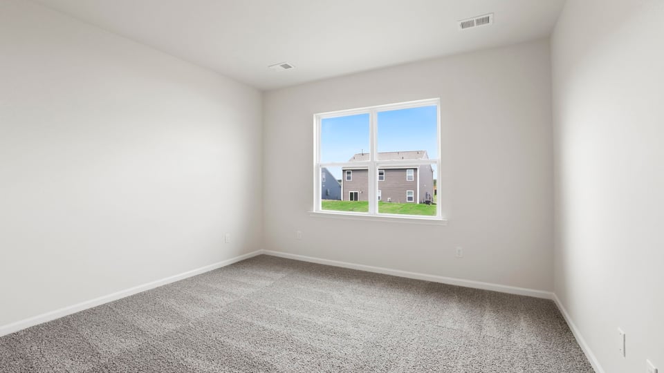 Loft with carpet and window.