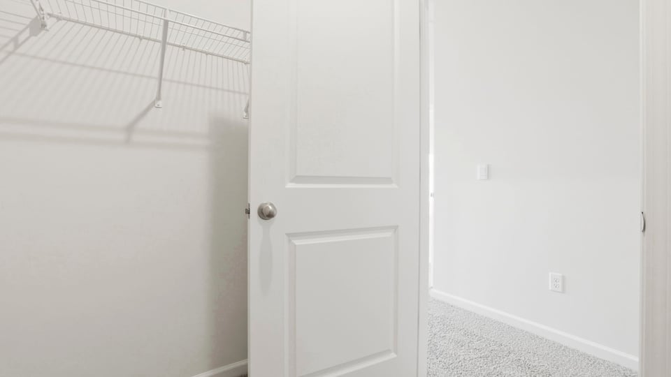 Primary closet with shelf.