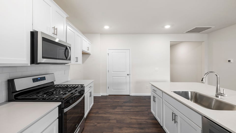 Kitchen and island have quartz countertops.