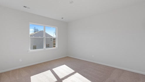 Bedroom with carpet and window.