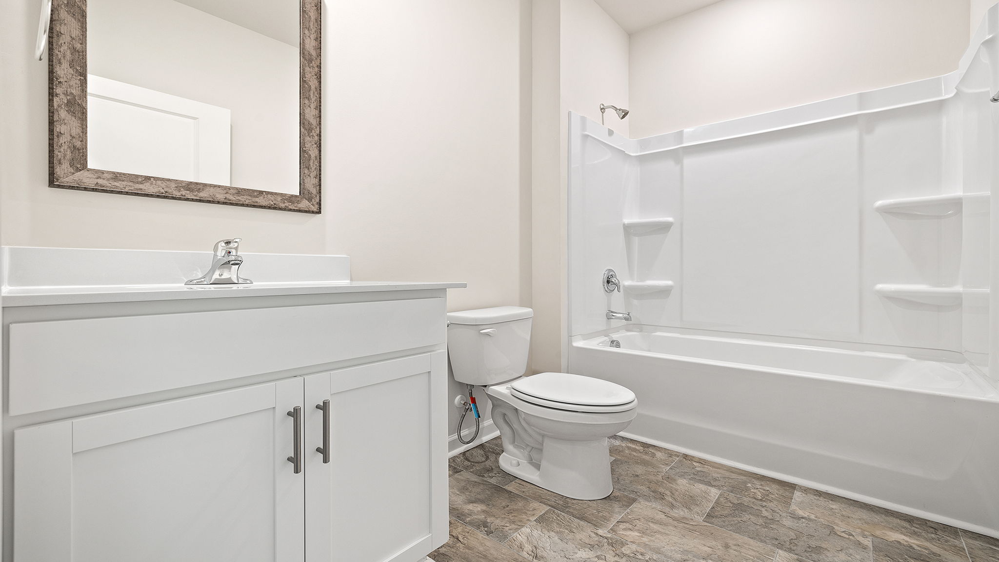Hall bathroom with vanity and combination shower / tub.