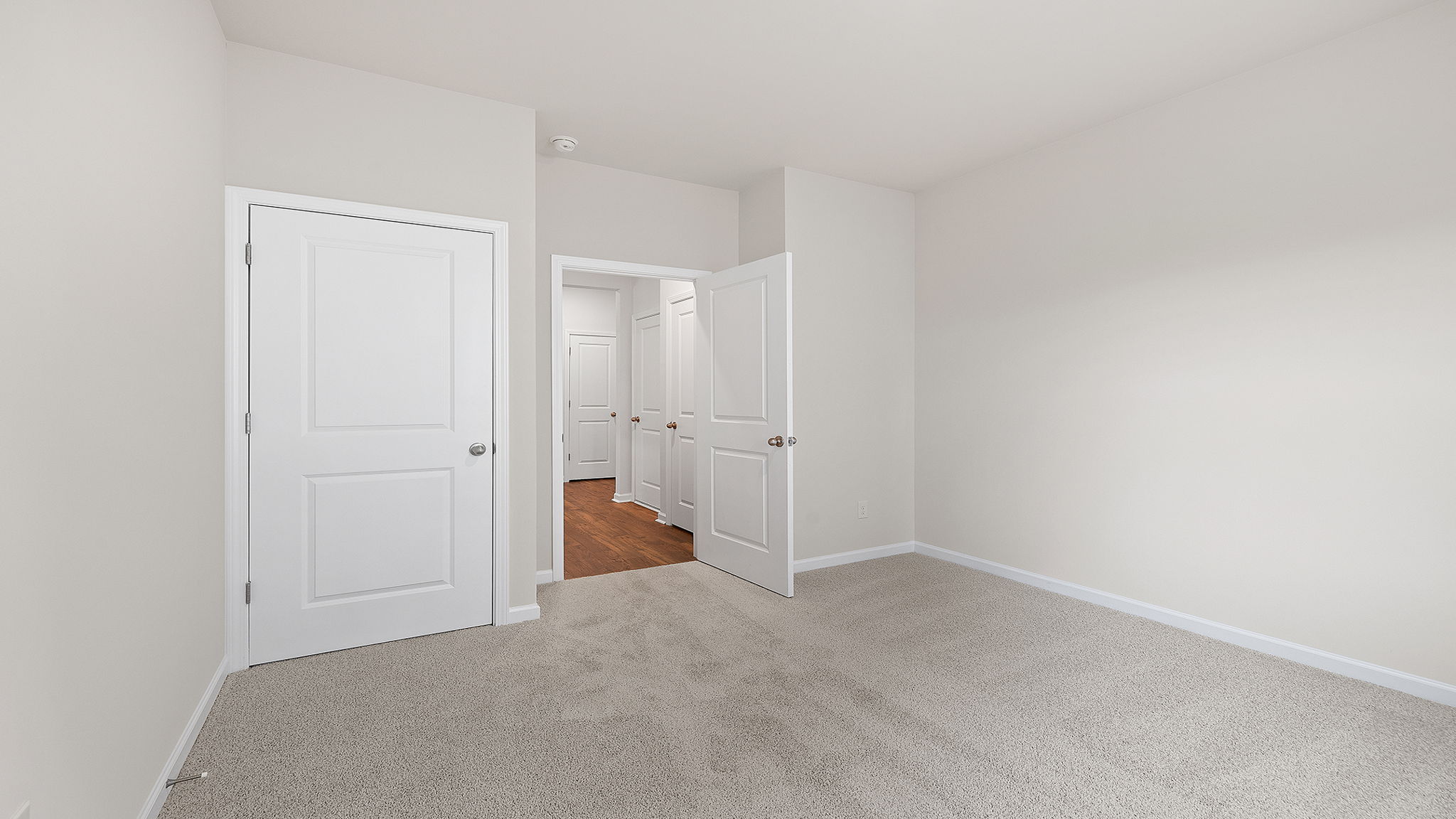 Bedroom with window and carpet.