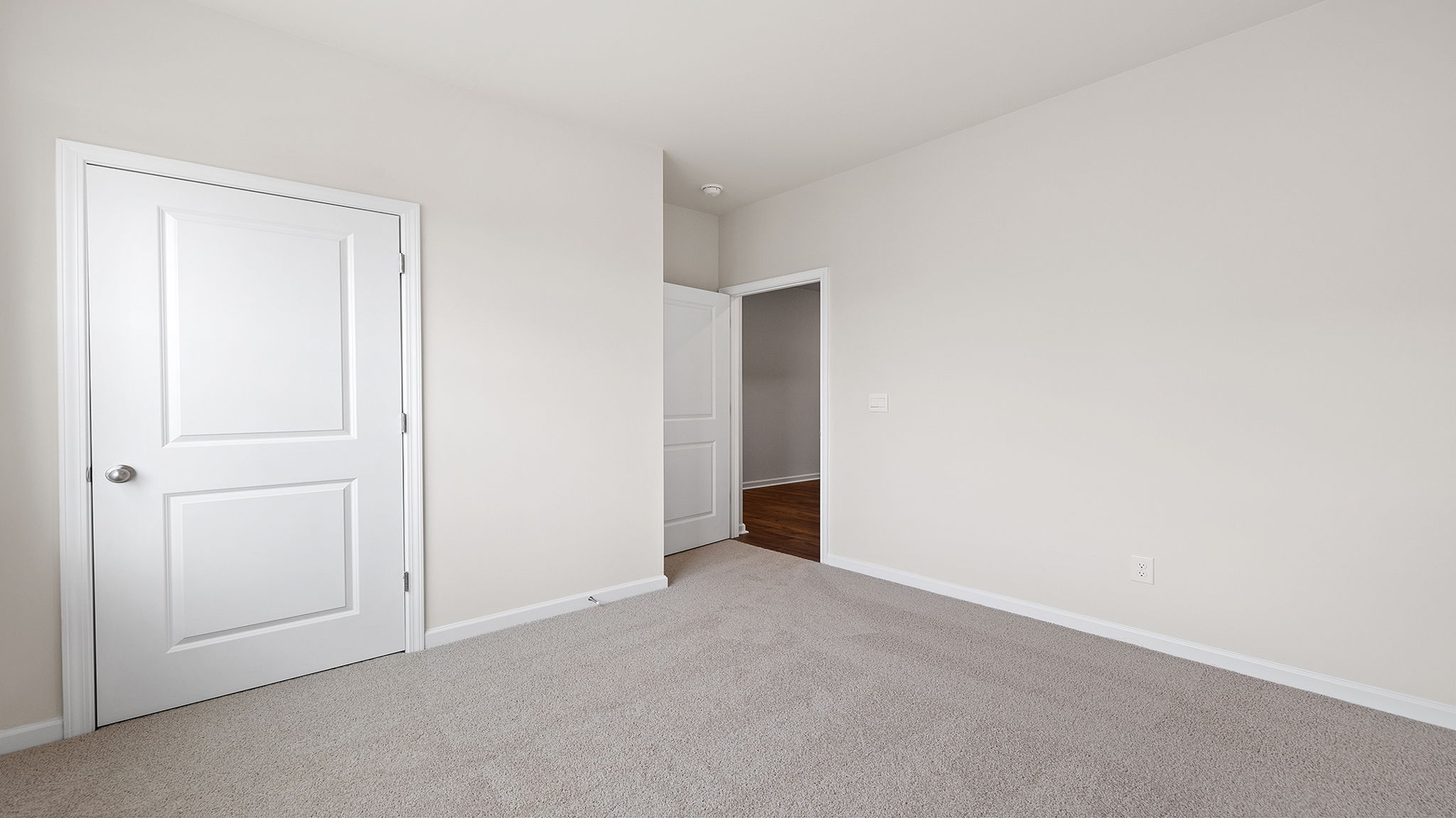 Bedroom with window and carpet.