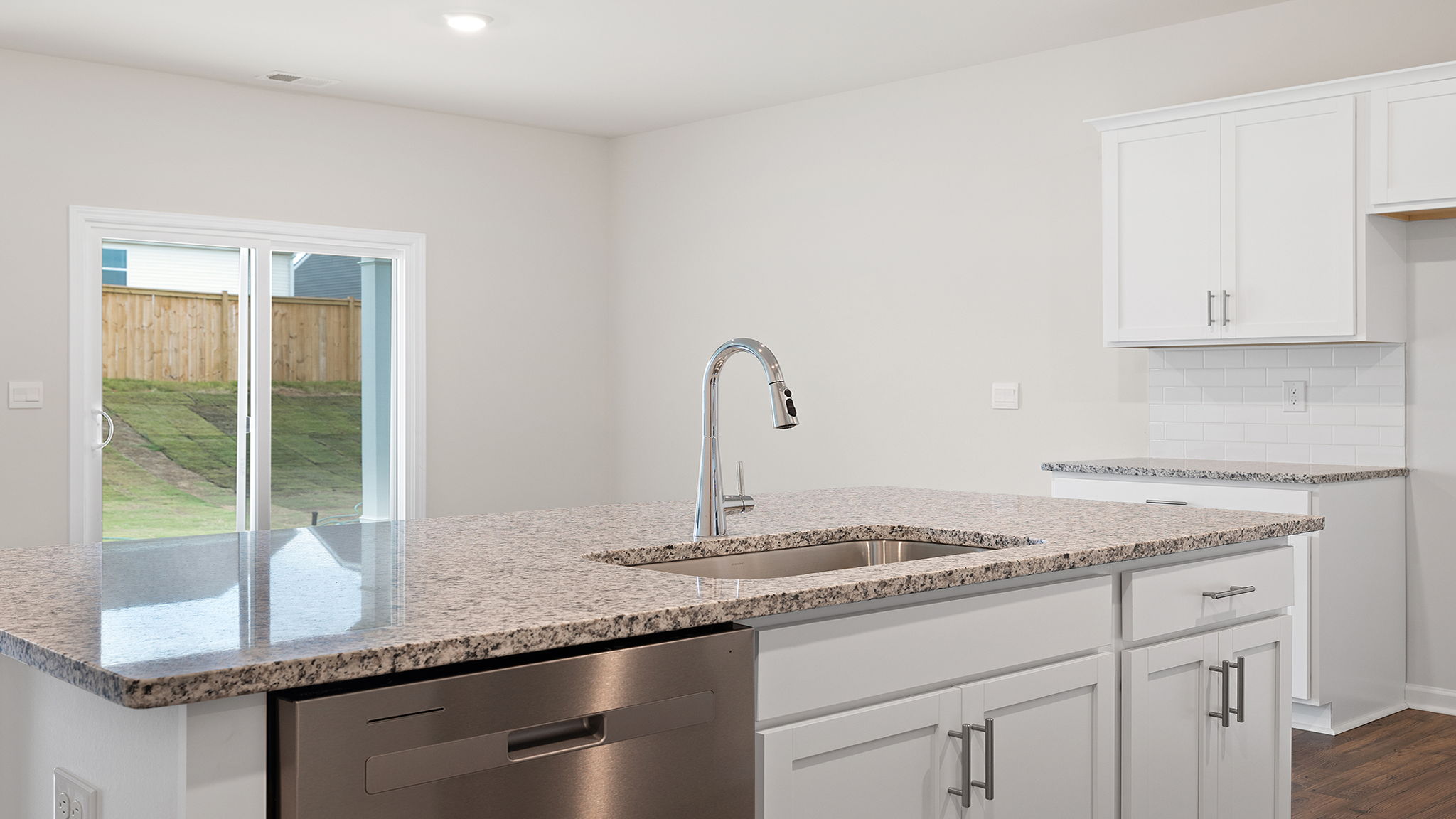 View from kitchen of dining area and doors to the covered porch.