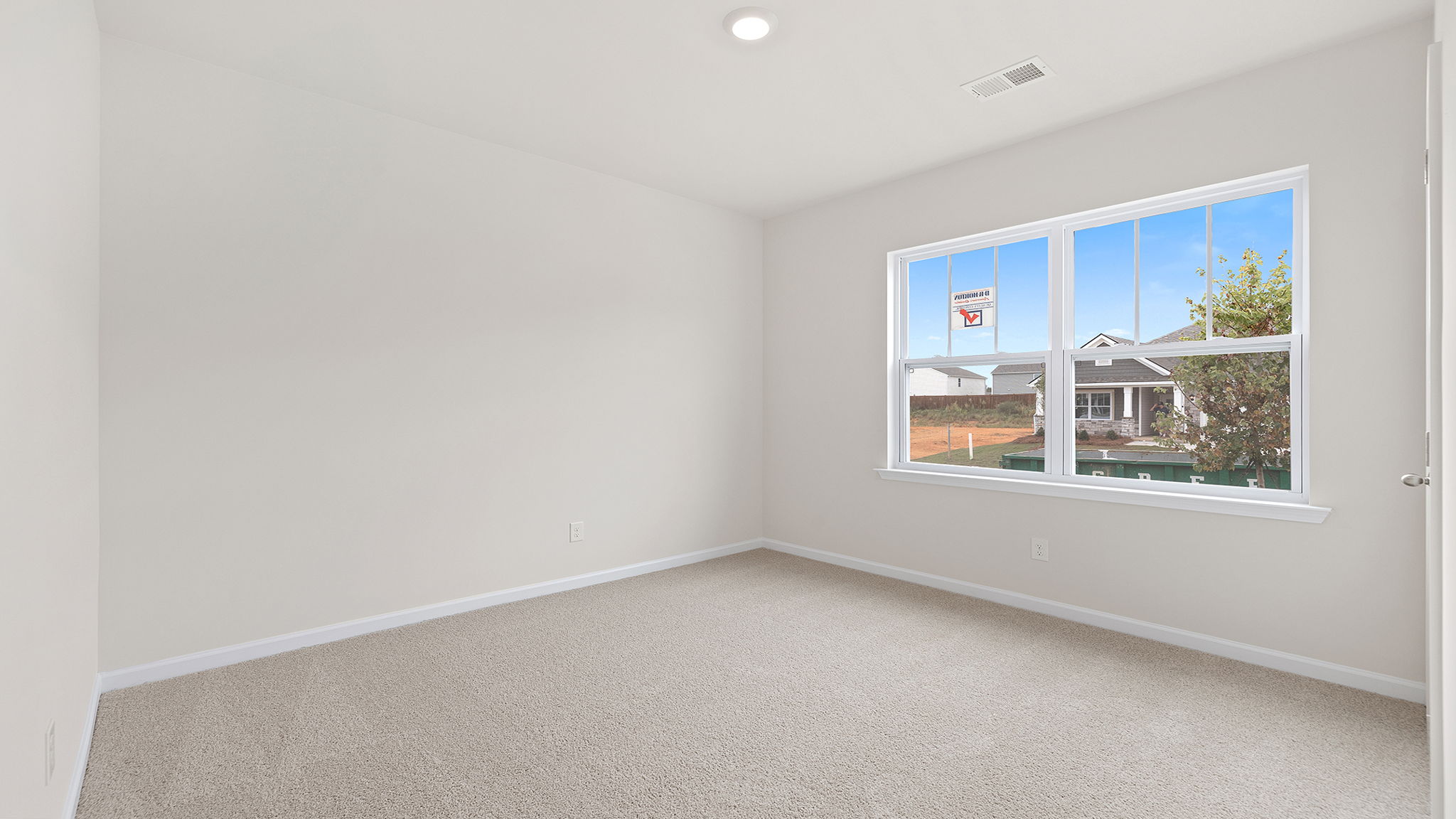 Bedroom with window and carpet.