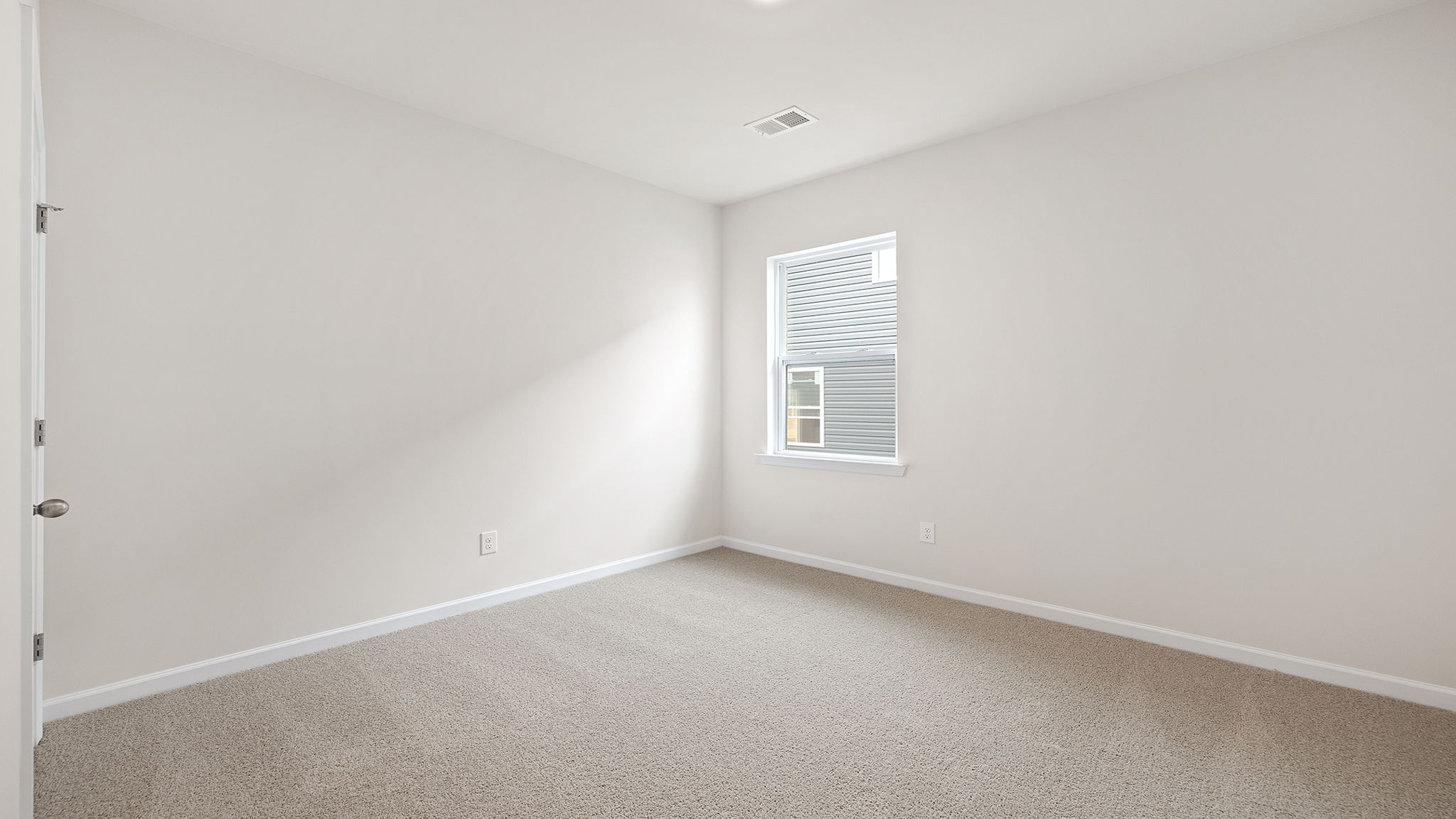 Bedroom with window and carpet.